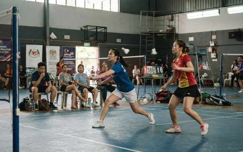 Two doubles teams shake hands at the net after a round robin match during a local pickleball tournament in Klang Valley